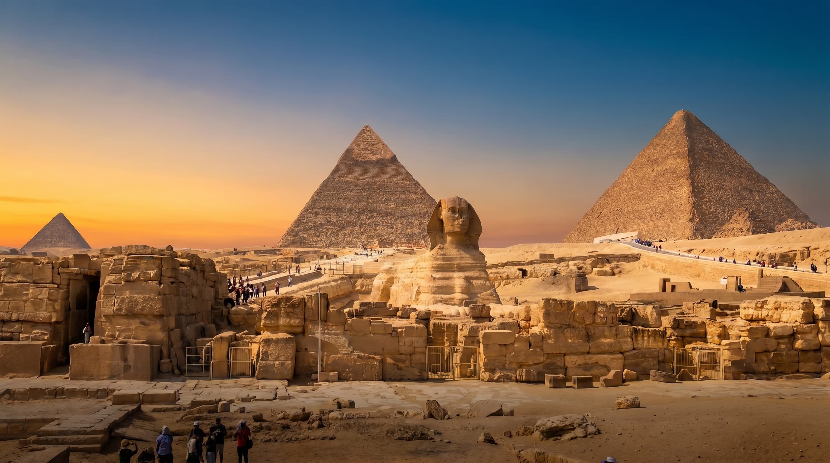 The Sphinx and the pyramids of Giza glowing at golden hour